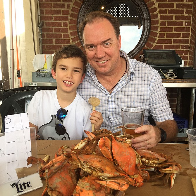 Sam and his dad back in U.S. with a pile of crabs.