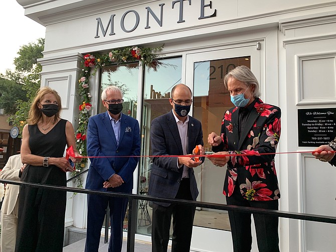 Monte Durham, right, cuts the ribbon at the grand opening of his new eponymous salon Sept. 12 in Old Town. With him are (l-r) Mickey Durham, Jack Evans and Mayor Justin Wilson.