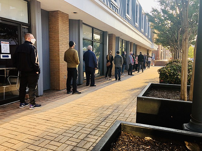 Voters line up outside the registrar’s office in Alexandria to cast in-person absentee ballots in this year’s election.