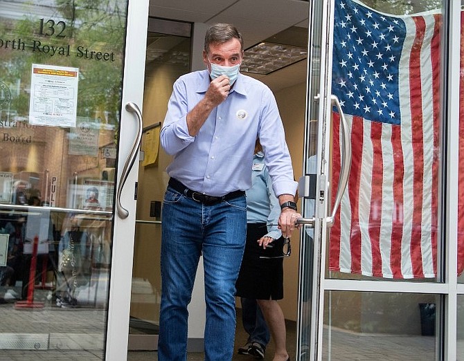 Senator Mark Warner leaves the Alexandria Voter Registrar’s Office Sept. 18 on the first day of early voting in Virginia.