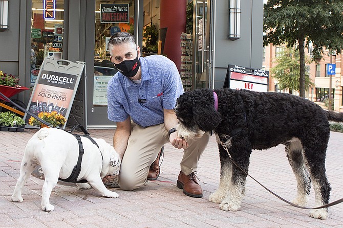 Twins Ace Co-Owner Jeff Smith greets customers Apollo and Rosie.