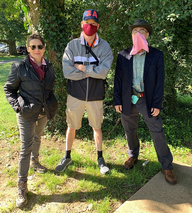 Fairfax County resident Michael Parker, center, gathers with Second Amendment supporters at the Dyke Marsh Wildlife Preserve for an open carry hike Sept. 19 along the Mount Vernon Trail.