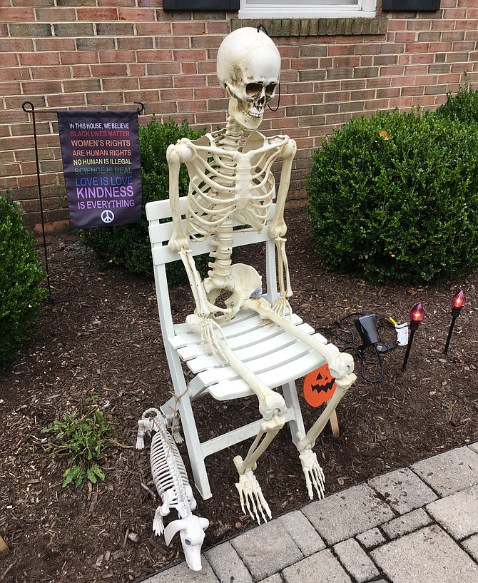 A man and his dog waiting for Halloween treats.