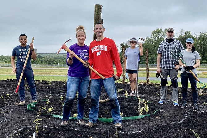 Dirt on hands and knees testify to the hard work of volunteer gardeners Aron Yabes, Fairfax Station; Craig and Lisa Schapira, Burke; Janet Vincent, Springfield; and Kate and Phil Stoneman, Tysons Corner.