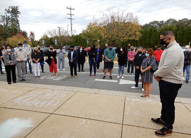 Attendees bowing their heads during the ceremony’s closing prayer.