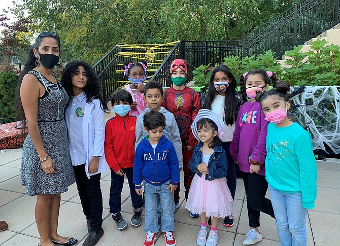 Spooky Mad Science Expo founder Zohreh Khoshnamak, left, poses for a photo with participants Oct. 17 at The Watergate at Landmark.