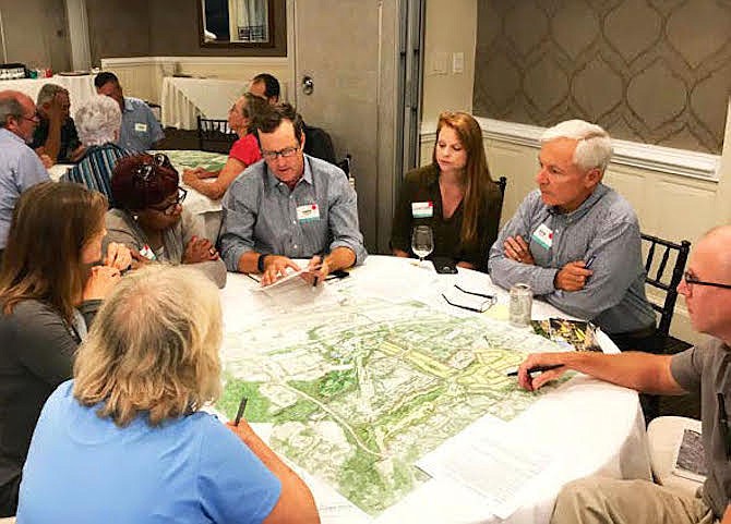 Planners use a charrette process to involve stakeholders and Reston participants in a collaborative, hands-on session to identify and discuss solutions as they explore possible plans for creating a 100-acre "Grand Park" with a range of housing options on the Hidden Creek Country Club property in Reston.