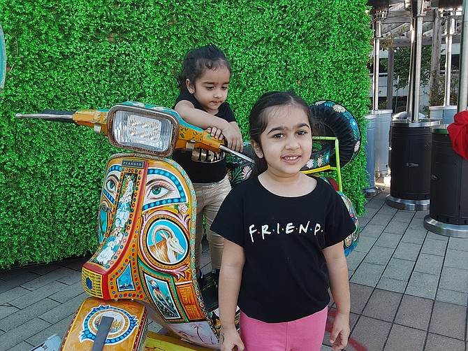 Children gravitate to the scooter at the outdoor Punjabi Dhaba in Springfield.