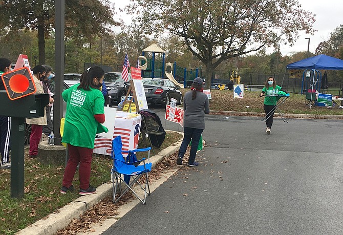 Candidate supporters are set up around the parking lot at Potomac Community Center. Early Voting Centers are open 7 a.m. to 8 p.m. all week including Saturday and Sunday, plus next Monday, Nov. 2. Election Day is Tuesday, Nov. 3, also 7 a.m. to 8 p.m.