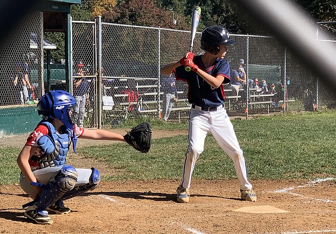 (From left) catcher Emmett Hildreth, 11, and batter Luke Brazie, 12, wait for the pitch. (Majors Division).