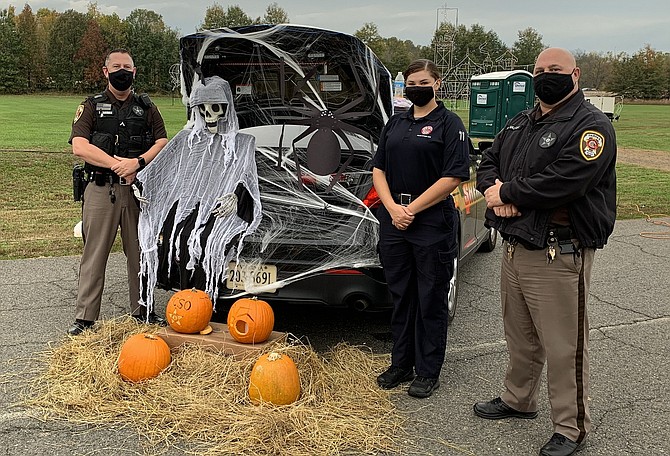 (From left) are Sgt. Thomas Harman (Sheriff’s Office); Police Citizen Aide Elizabeth Proper and PFC Morgan Walker (Sheriff’s Office) with their spooky display.