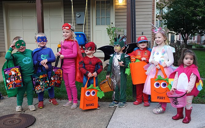 Children of Powhatan Place in North Old Town gather for a photo prior to trick-or-treating at a neighborhood Halloween gathering Oct. 30.