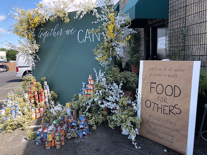 The sign outside Sweet Root Village's pop up features the charity for which it was raising money during its September event.