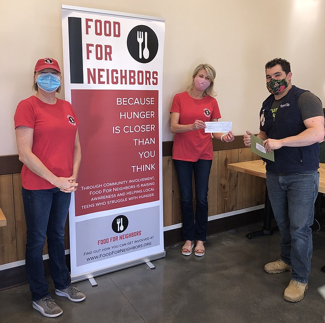 Bryan Daniell (right), Assistant Manager of Sprouts Farmers Market in Herndon, presents Food For Neighbors volunteers Romy Nathan (middle) and Renee Maxwell (left) with $5,000 to support Food For Neighbors in its grassroots effort to end child hunger.