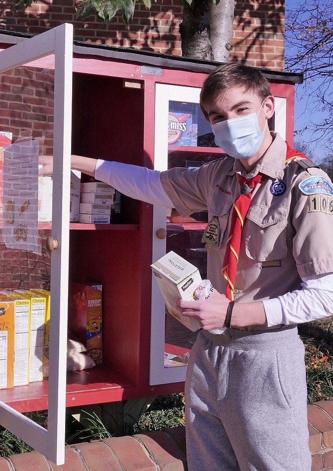 On the morning of his Eagle Scout Review Board, Charlie Gaylord inspects the food donations in the “Little Free Pantry” that he constructed for his Eagle Scout Project.