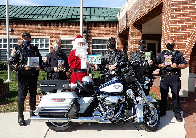 Holding some of the Christmas gifts donated for Santa’s Ride are (from left) MPO Ben Kushner, MPO Meg Hawkins, Santa Claus, PFC R.B. Kitchens, MPO Dave Pierce and APO Tony Gul.