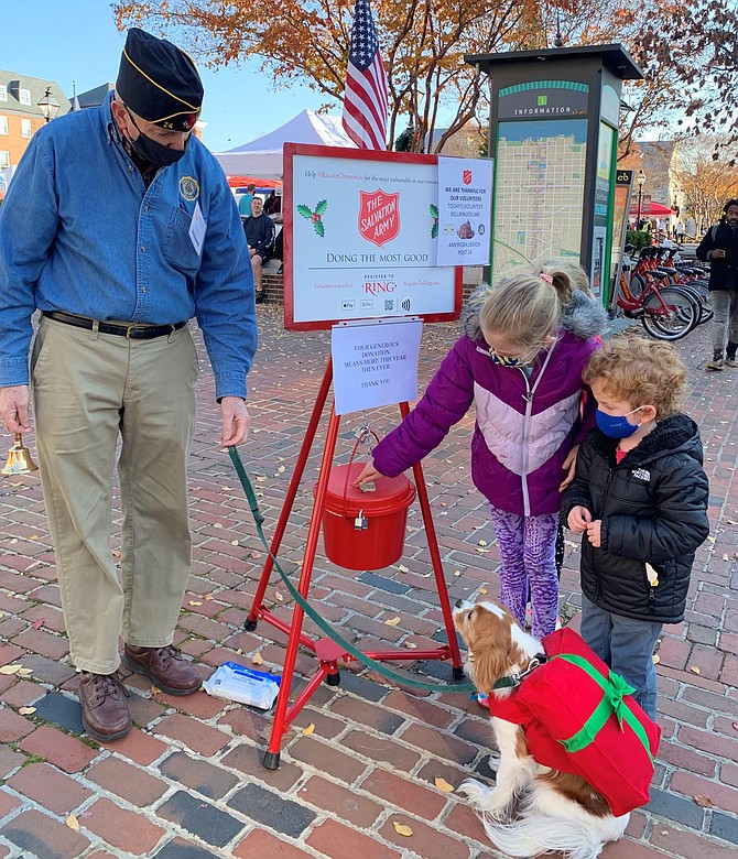 American Legion Post 24 Commander Henry Dorton, left, looks on as a donation is made to the Salvation Army Red Kettle Campaign Nov. 28 at Market Square. The annual donation drive runs through Dec. 24.