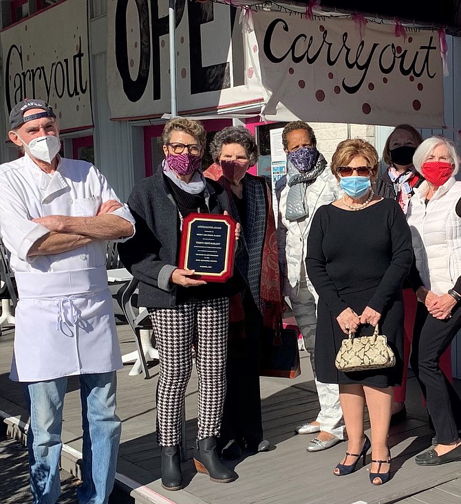 Members of the Board of Lady Managers present Tempo Restaurant owners Serge and Wendy Albert, left, an appreciation award Nov. 18 for their longstanding and generous contributions to the Board of Lady Managers. The organization provides vital medical equipment and services to Inova Alexandria.