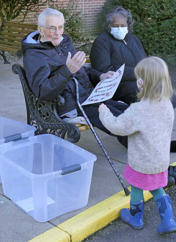 Indigo Sanders, who lives in the neighborhood on 25th Street next to Missionhurst, made a homemade sign for Father John van de Paer’s 100th birthday parade on Sunday, Nov. 29.