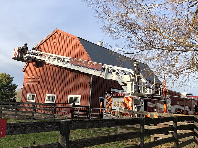 Staff at Fairfax County Fire Station 36 - Frying Pan Park get ladder truck training as they decorate the Park Authority's barn at Frying Pan Farm Park.