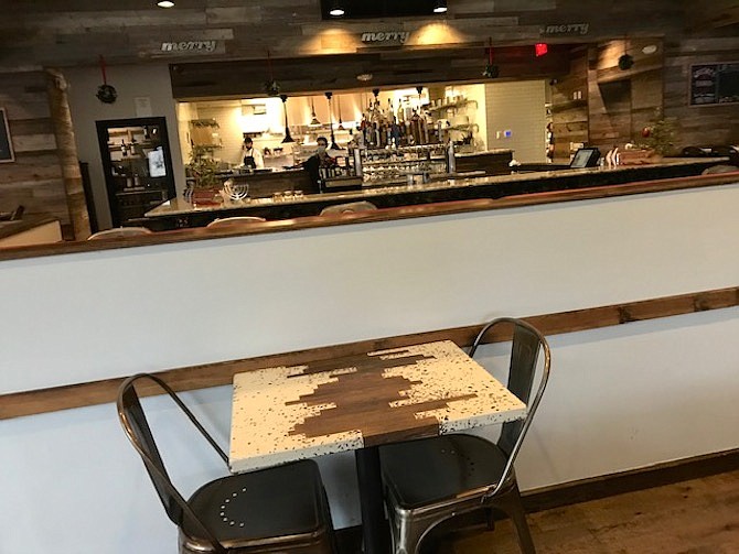 A look from the dining area into the bar area and seating.