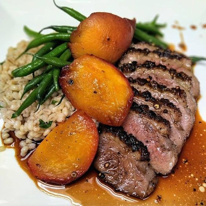 Magret de Canard dish at Bastille: seared Hudson Valley duck breast is served with quinoa and Medjool date jam.