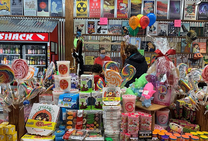 Owner Tonya Kemp helps a customer check out on opening day of Rocket Fizz Soda Pop & Candy shop Dec. 11 in Fairlington Centre.