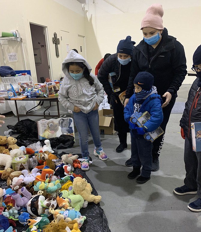 Attendees browse a selection of stuffed animals during the Firefighters and Friends toy distributions day Dec. 19 at My Father’s House Christian Church International.