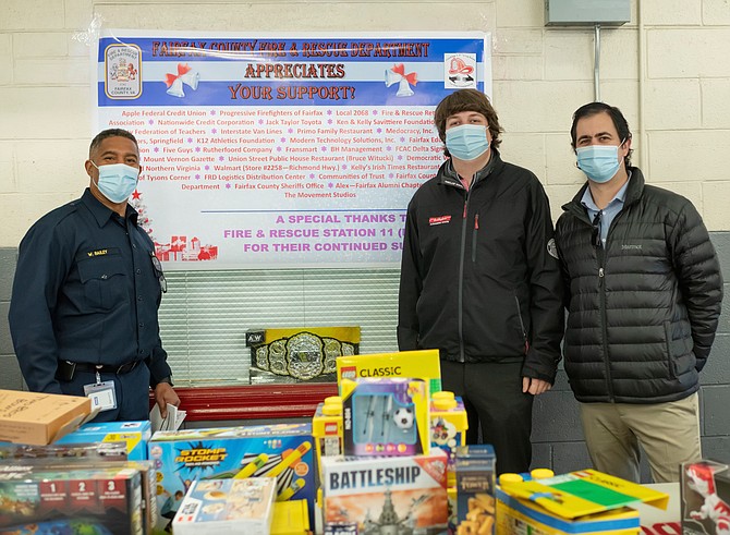 Fairfax County Fire and Rescue Deputy Chief Willie Bailey, left, with John Taylor of Jack Taylor’s Alexandria Toyota and Alexandria Toyota marketing manager Andrew Mitchell at the Fairfax County Fire and Rescue and Firefighters and Friends annual toy drive distribution Dec. 15 at Penn Daw Fire Station 11. Jack Taylor’s Toyota was a major sponsor of this year’s toy drive.