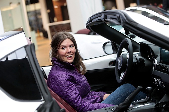 Kristina Davis, a COVID ward nurse and health policy graduate, smiles as she sits inside her new special edition Mazda MX-5 Miata Dec. 15 at Brown’s Alexandria Mazda.