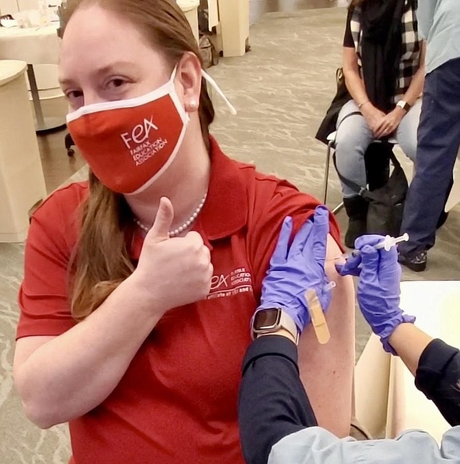 Fairfax Education Association President (FEA), Kimberly Adams, receives her Covid-19 vaccination jab on the first day of the closed vaccine clinic at INOVA.