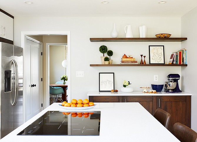 Island seating and cooking provide prep and entertainment spaces in this Winn Design + Build kitchen and rear addition project in Arlington, Virginia.