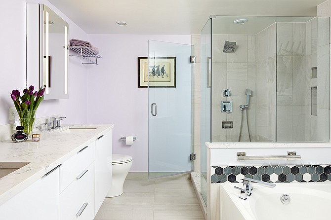 Case Architects & Remodelers created a seat nook in the enlarged shower in this modern Alexandria, Virginia bathroom.