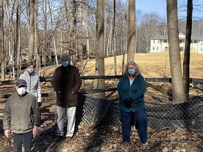 (From left)  Jeanne LeFevre and David Weisman, residents at 11124 Corobon Lane, adjacent to 11118 Corobon Lane, the construction site, Bill Denk, Co-chair GFCA Environment & Park Committee and Jennifer Falcone, Chair GFCA Land Use & Zoning Committee gather on the edge of Corobon Lane in Great Falls that overlooks the residential construction.