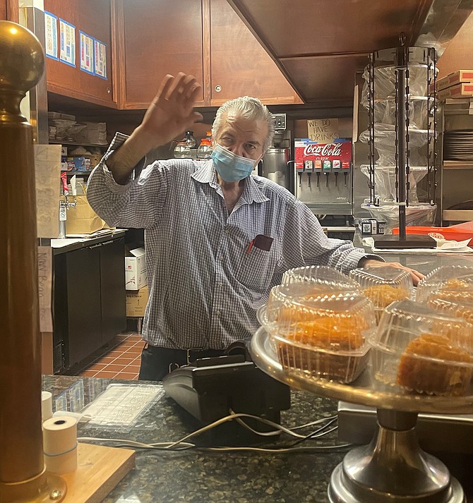 Atlantis Family Restaurant owner Bill Patrianakos gives a wave to patrons Jan. 18 after the sudden announcement that the restaurant will be permanently closing Jan. 24 after 38 years in business.