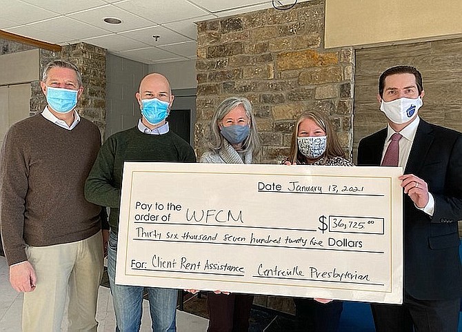 (From left) Rob Bromhead, Aaron McMillan and Sharon Hoover, of Centreville Presbyterian Church, present the rent-relief check to WFCM’s Harmonie Taddeo and Andrew Casteel.