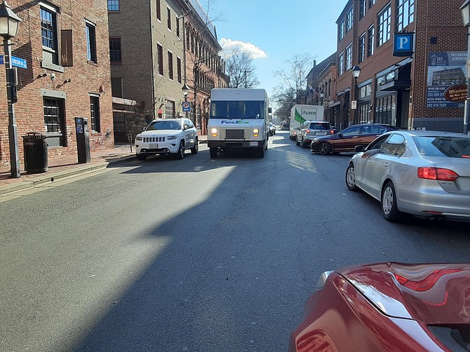This FedEx truck in Old Town Alexandria is not only blocking the street in both directions, but also the side street that feeds into it.