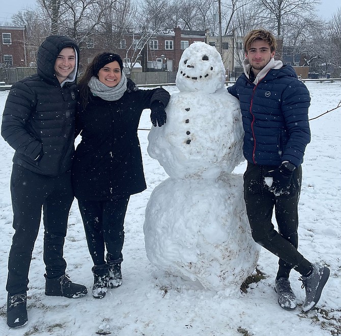 Shawn Seruya, Emilie Trudeau and Stephen Seruya with their snowman “Paul” Jan. 31 in Four Mile Run Park.