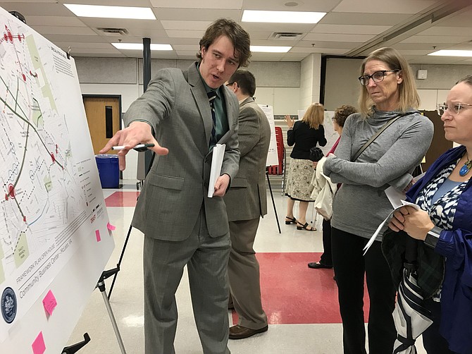 On Sept. 27, 2018, when Streetsense presented the Framework Plan Open House for the CBC, Zachary Krohmal, Transportation Planner for Fairfax County Department of Transportation, looked at the display panels with McLean residents Carol Dinion and Erin Thiebert.  He said, "Some ideas may be possible and doable; some may not." (File Photo)