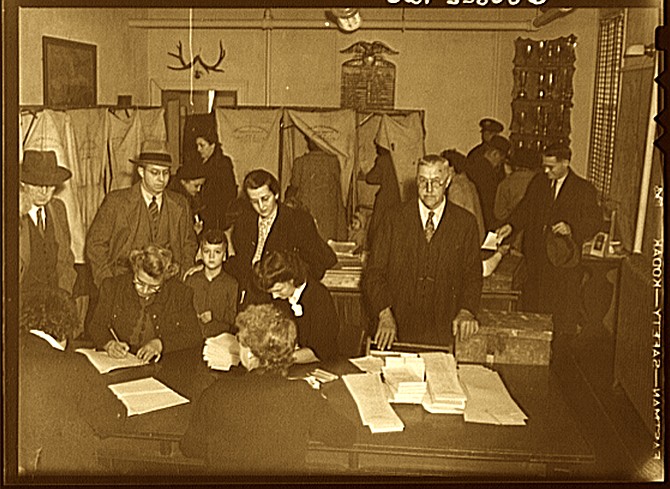Election officials check poll tax records at an Arlington precinct in 1944.