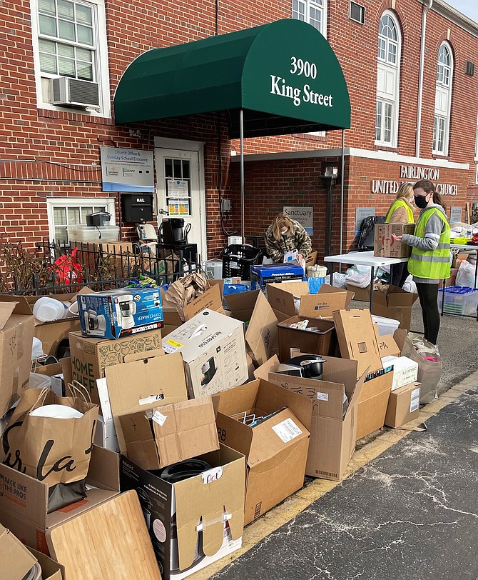 A volunteer looks over boxes of donated goods during the Alive! housewares donation day Feb. 6 at Fairlington United Methodist Church.