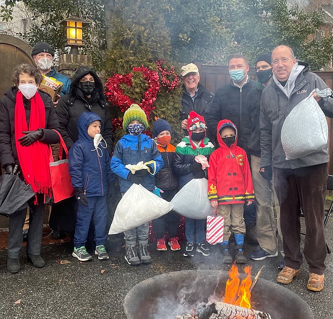 Former City Councilman Frank Fannon, right, poses for a photo with donors Feb. 13 during the 13th annual Alexandrians Have Heart food and clothing drive.