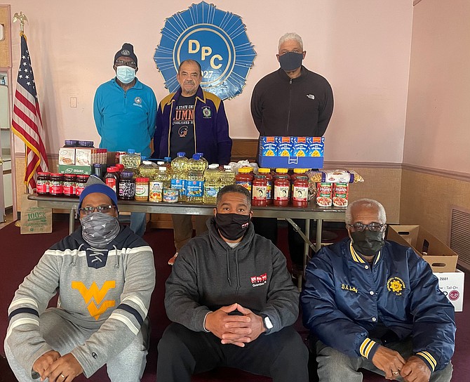 Departmental Progressive Club president Nelson Green Jr., center back, with DPC members at the club’s Feb. 20 food drive. Pictured clockwise from back left: Joseph Jennings, Nelson Greene Jr., William Chesley, Daniel Shelby, Willie Bailey and Bill Campbell.