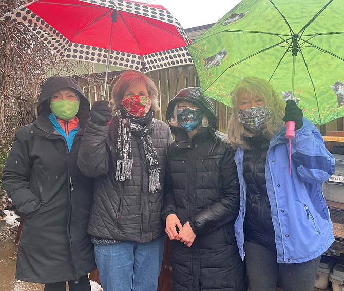 Volunteers Lynda DiValentin, Sarah Rasmussen, Ginny Richards and Marta Ishmael gather Feb. 22 to feed and care for a feral cat colony in Arlandria. (Names corrected March 6, 2021)