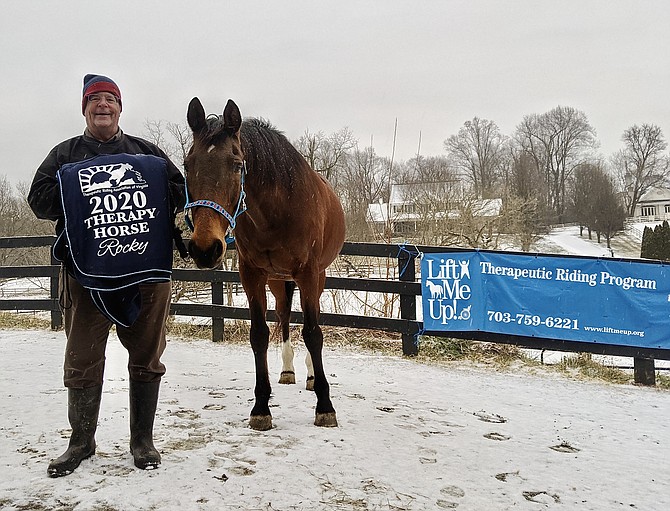 RockStar and volunteer Pierce Bates pose with the “Therapy Horse of the Year” prize blanket.