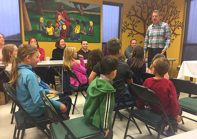 The Rev. Rob Bromhead speaks to children and parents at a CPC Communion Workshop.