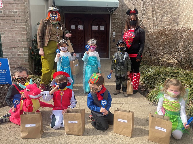 Teachers Charlotte Buckhold and Brandy Smith with the kitah sagol (purple class) in their costumes and Mishloach Manot, bags of goodies celebrating Purim at Agudas Achim Congregation Feb. 26.