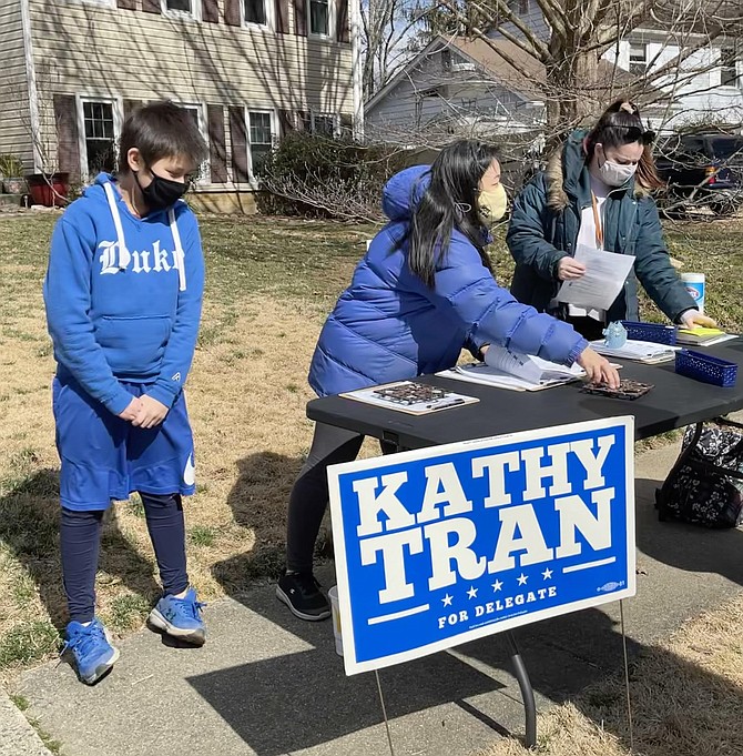 Incumbent Delegate Kathy Tran (center) gets support from her son Daven and campaign manager Ashley Wolsefer, as she reaches out for signatures for her third term run in District 42.