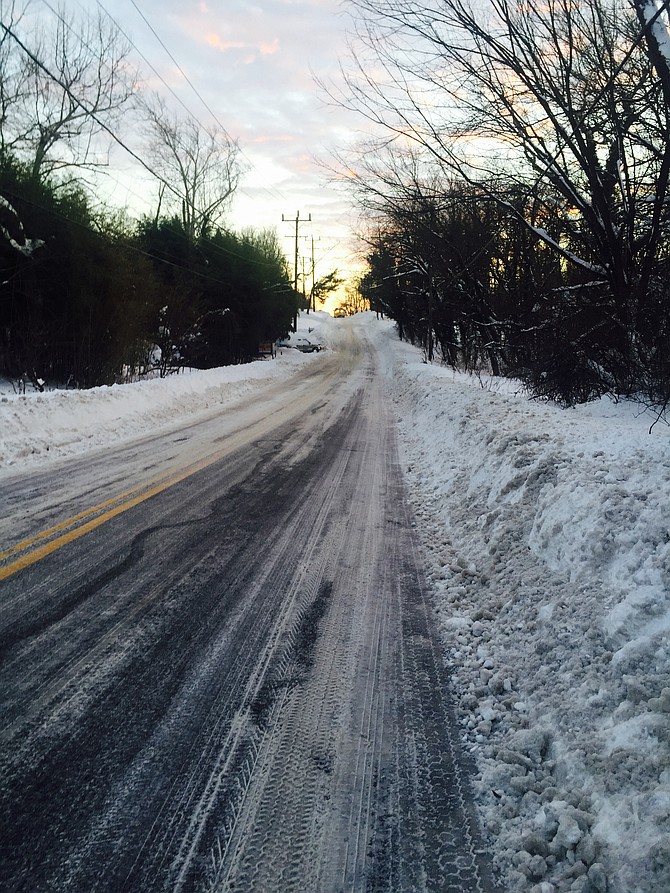 Snow on Falls Road near bus stops.