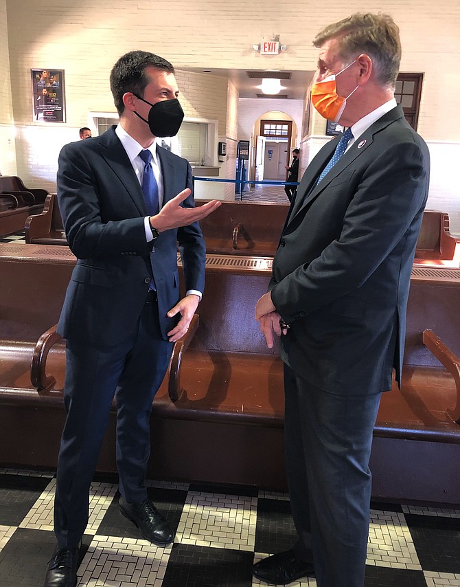 Peter Buttigieg, U.S. Secretary of Transportation, talks with U.S. Rep. Don Beyer in Alexandria on Tuesday, March 30.